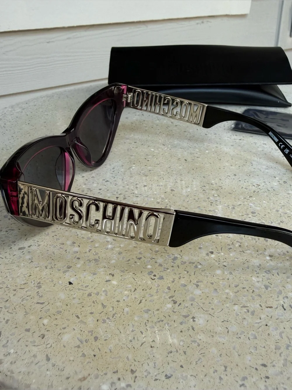 Moschino Womens Black Cat-Eye Sunglasses with Subtle Pink Trim & Silver Hardware